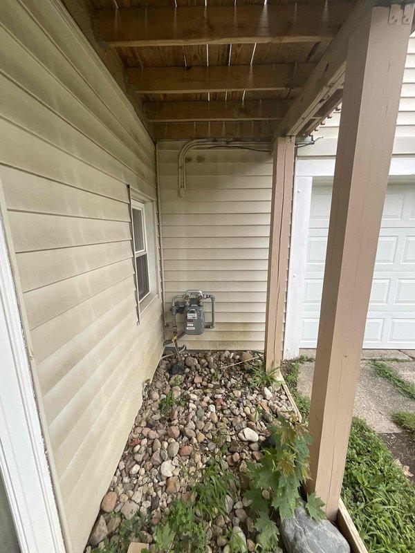 Conducted comprehensive site assessment for whole-home generator installation at an eight-year-old residential property. Evaluated existing electrical infrastructure, including main service panel location in basement utility area and exterior meter placement along side access corridor. Documented electrical panel configuration, available circuit capacity, and optimal installation pathway for transfer switch integration. Assessed exterior mounting location accessibility between house and garage structure, noting adequate clearance for generator placement on rock bed landscape area with proper setback from building envelope. Reviewed utility service entrance configuration and conduit routing requirements for natural gas or propane fuel line connection. Photographed existing electrical distribution equipment and proposed installation site to facilitate accurate material estimation and equipment sizing recommendations. Discussed equipment options with homeowner, including Kohler and Genera