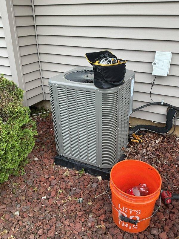 Performed comprehensive AC tune-up on 12-year-old residential system with outdoor condenser unit located in backyard and Bryant furnace with air handler in basement. Completed full system inspection including condenser coil cleaning, refrigerant level verification, electrical connection testing, and airflow assessment. Verified proper operation of condensate drainage system and humidifier attachment, checked all PVC drain lines for blockages, and confirmed system cycling and temperature differential met manufacturer specifications.