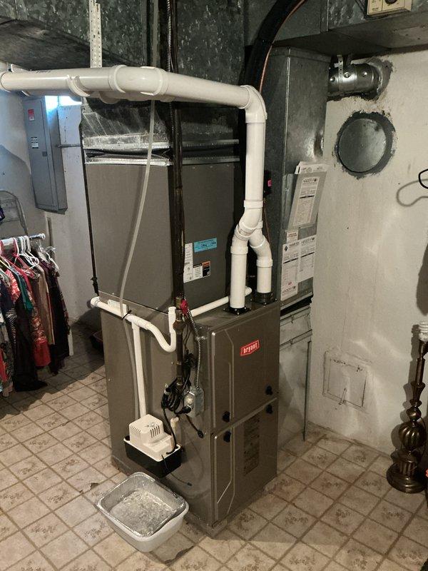 Performed comprehensive AC tune-up on 12-year-old residential system with outdoor condenser unit located in backyard and Bryant furnace with air handler in basement. Completed full system inspection including condenser coil cleaning, refrigerant level verification, electrical connection testing, and airflow assessment. Verified proper operation of condensate drainage system and humidifier attachment, checked all PVC drain lines for blockages, and confirmed system cycling and temperature differential met manufacturer specifications.