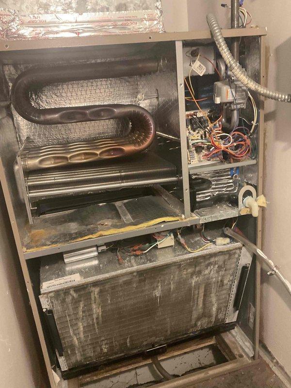 Performed comprehensive assessment of non-operational basement air conditioning system with unknown age. Upon inspection, identified heavily soiled evaporator coil with significant dust and debris accumulation, compromised air filtration system, and drainage pan exhibiting extensive discoloration and staining indicative of prolonged moisture exposure. Documented deteriorated internal components including control board, wiring connections, and heat exchange surfaces showing substantial wear. Provided detailed replacement estimate for complete HVAC system due to overall condition and operational failure of existing equipment.