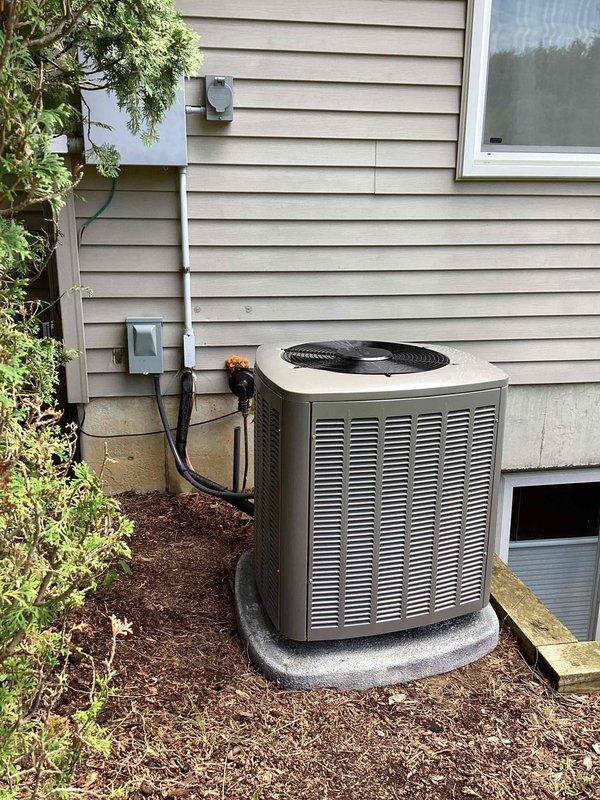 Completed full HVAC system installation including a 70,000 BTU furnace with rear return configuration, 2-ton air conditioning unit, and whole-home humidifier. Unit positioned on concrete pad with proper electrical conduit installation, disconnect box mounting, and all refrigerant line connections completed per manufacturer specifications. All mechanical and electrical permits obtained, system tested and operational upon departure.