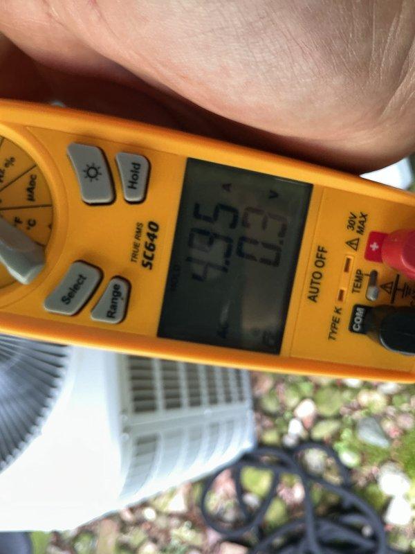Responded to service call for 2-year-old air conditioning system not cooling home adequately. Performed diagnostic evaluation of outdoor condenser unit located in garage area. Assisted with installation of new air filter provided on-site. Conducted electrical testing and measurements using digital multimeter to verify system performance and identify potential issues affecting cooling capacity. Documented readings and system conditions with diagnostic photos for service records.