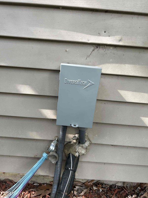 Responded to no cooling call on 1.5-year-old air conditioning system where outdoor fan was running but compressor failed to engage. Upon arrival, verified outdoor fan motor operation and confirmed compressor was not starting. Inspected electrical disconnect switch at outdoor unit and found switch in ON position with proper power supply to disconnect box. Checked voltage at disconnect and confirmed incoming power present. Performed visual inspection of condenser unit wiring and connections. Documented electrical disconnect installation and current system status with photos showing DiversiTech disconnect box mounted on exterior wall with conduits properly secured. System requires further diagnostic testing to determine root cause of compressor failure, including checking contactor operation, capacitor values, and compressor windings. Recommended follow-up service to complete electrical diagnostics and determine if compressor, contactor, or control board replacement is necessary to restor