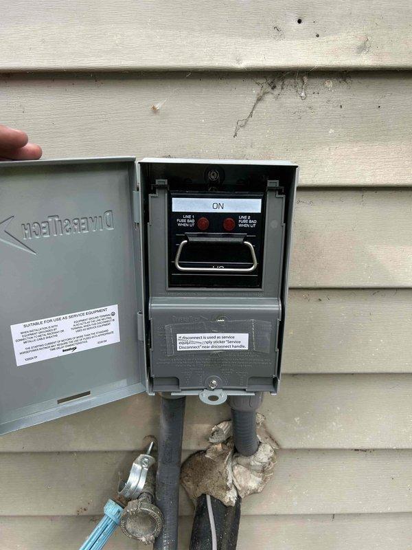 Responded to no cooling call on 1.5-year-old air conditioning system where outdoor fan was running but compressor failed to engage. Upon arrival, verified outdoor fan motor operation and confirmed compressor was not starting. Inspected electrical disconnect switch at outdoor unit and found switch in ON position with proper power supply to disconnect box. Checked voltage at disconnect and confirmed incoming power present. Performed visual inspection of condenser unit wiring and connections. Documented electrical disconnect installation and current system status with photos showing DiversiTech disconnect box mounted on exterior wall with conduits properly secured. System requires further diagnostic testing to determine root cause of compressor failure, including checking contactor operation, capacitor values, and compressor windings. Recommended follow-up service to complete electrical diagnostics and determine if compressor, contactor, or control board replacement is necessary to restor