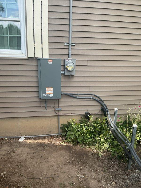 Coordinated utility disconnect and reconnect services with power company for electrical panel upgrade and transfer switch installation. Installed Kohler transfer switch with proper conduit runs and metering equipment on exterior wall, ensuring all components met code requirements for State of Michigan inspection. Successfully completed installation with inspector approval before utility reconnection, verifying all circuits properly labeled and operational in main distribution panel.
