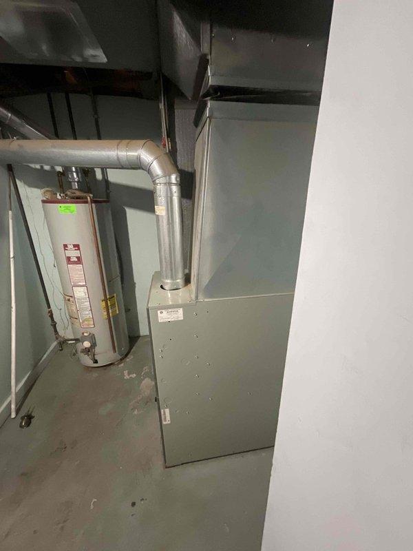 Completed on-site evaluation for central air conditioning installation estimate at single-family residence with existing forced-air heating system. Assessed basement mechanical room containing water heater, existing ductwork infrastructure, and electrical panel to determine compatibility and requirements for AC integration. Evaluated exterior electrical service panel and meter configuration on home's exterior wall to verify adequate electrical capacity for new air conditioning condenser unit installation and confirmed suitable outdoor placement location for equipment.