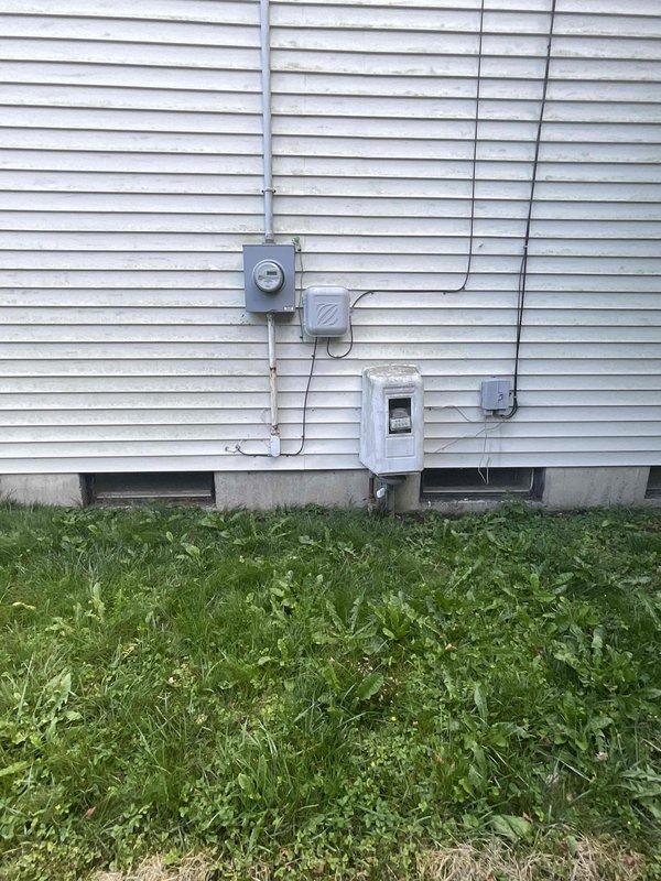 Completed on-site evaluation for central air conditioning installation estimate at single-family residence with existing forced-air heating system. Assessed basement mechanical room containing water heater, existing ductwork infrastructure, and electrical panel to determine compatibility and requirements for AC integration. Evaluated exterior electrical service panel and meter configuration on home's exterior wall to verify adequate electrical capacity for new air conditioning condenser unit installation and confirmed suitable outdoor placement location for equipment.