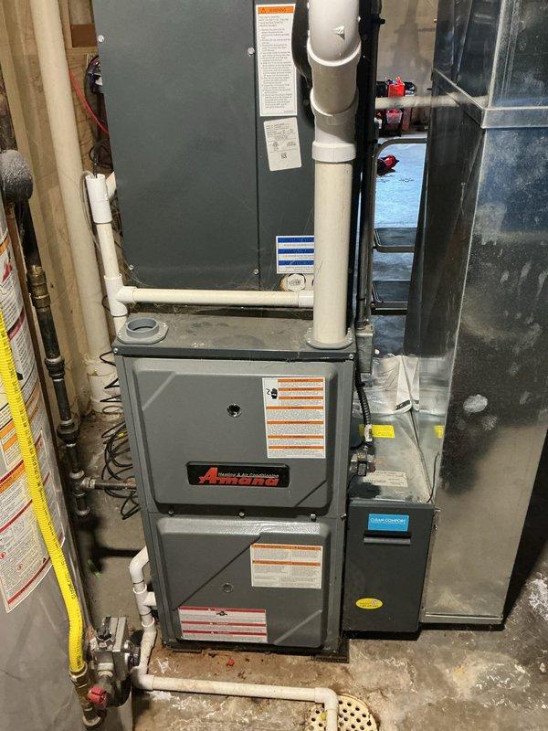Completed comprehensive Annual HVAC Checkup on residential forced-air heating and cooling system located in basement utility room. Performed thorough inspection of furnace unit, including visual examination of all accessible components, electrical connections, gas valve assembly, blower motor, capacitor, and control board. Documented system condition with detailed photography showing proper installation of venting, clear access to all serviceable components, and overall equipment functionality. All systems operating within normal parameters with no immediate service needs identified.