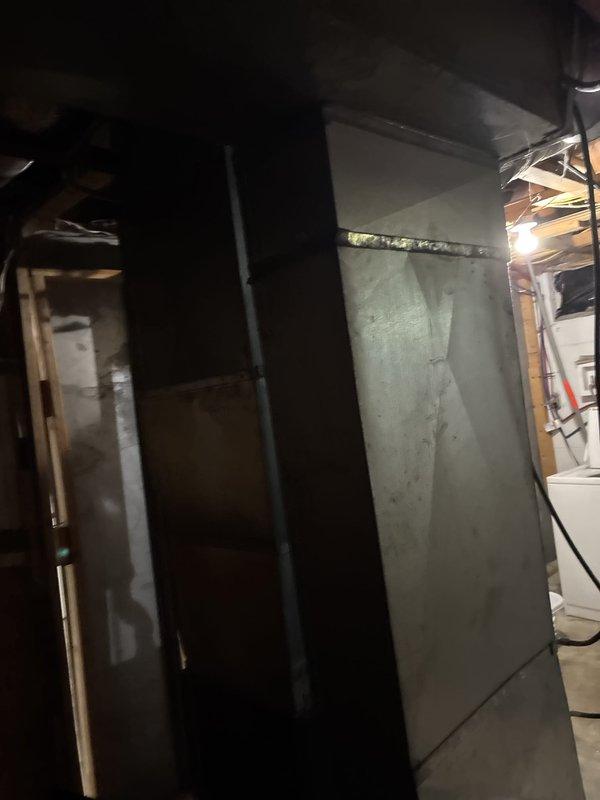 Conducted comprehensive assessment of 20-year-old furnace and generator system located in basement mechanical room. Current equipment operational but nearing end of service life. Evaluated existing gray HVAC furnace with complex PVC venting system, including multiple vertical risers and horizontal runs with elbow joints for proper combustion air and condensate drainage. Inspected refrigerant lines, electrical connections, and ductwork configuration. Documented equipment specifications, clearances, and existing infrastructure including water heater proximity, exposed framing, and available space for new installations. Provided replacement estimate for modernized high-efficiency furnace and generator system to improve reliability, energy efficiency, and performance.