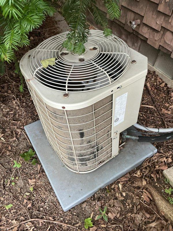 Performed routine maintenance on residential air conditioning system. Determined and replaced air filter per customer request, as original size was unknown. Inspected outdoor condenser unit, which showed significant accumulation of dirt, debris, and environmental buildup on protective grille and housing. Completed standard tune-up procedures including system performance evaluation and operational checks to ensure proper cooling function.