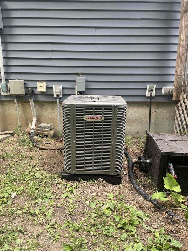 Completed full HVAC system installation including a 70,000 BTU furnace with flue liner and a 2-ton rear-discharge air conditioning unit. Installed Aprilaire whole-home humidifier with copper supply line and integrated into ductwork system. All equipment professionally mounted in basement mechanical room with proper venting and drainage. Outdoor Lennox condenser unit positioned on pad with appropriate clearance from building exterior. System reconnected to existing electrical service with proper disconnect installed. All permits obtained and installation completed to code specifications.