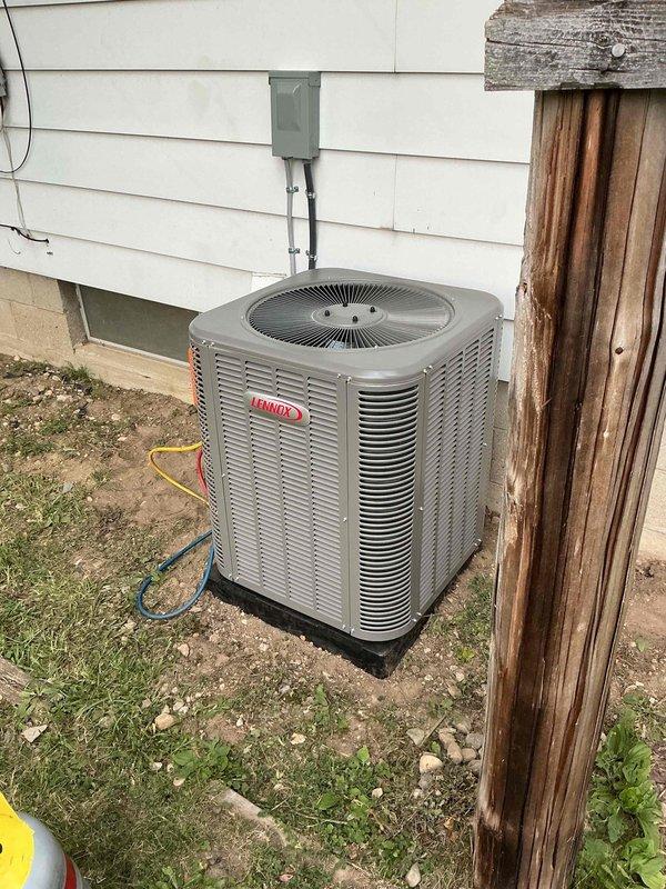 Completed installation of a 2-ton Lennox air conditioning system with matching evaporator coil at rear of residence. Obtained mechanical and electrical permits, installed outdoor condensing unit on pad with proper refrigerant line set and electrical disconnect, connected indoor evaporator coil to existing ductwork in basement utility area, and performed system startup and testing. All work completed per code requirements with system operational and ready for service.