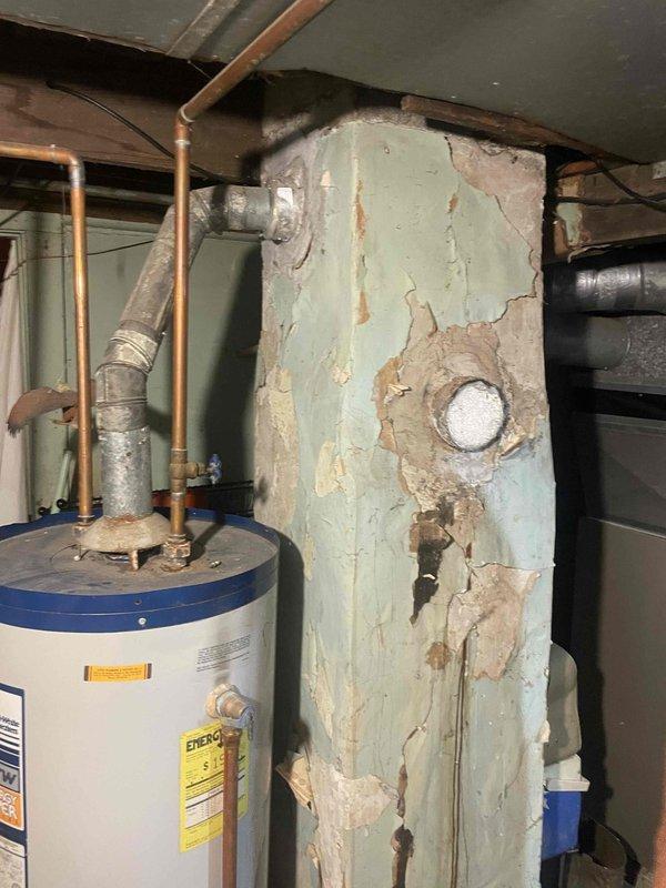 Performed plumbing estimate for standard water heater replacement in colonial home. Current natural draft water heater is operational but experiencing water leakage. Assessed existing unit configuration, measured equipment dimensions, and documented installation area conditions including copper supply piping connections and natural draft venting system. Evaluated basement mechanical room space and existing infrastructure to determine replacement requirements for new standard tank-type water heater with natural draft venting.
