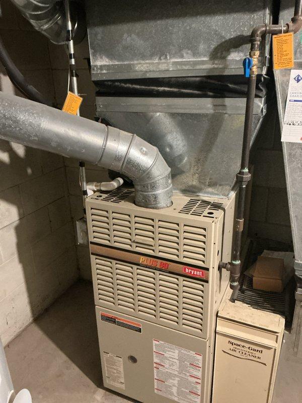 Completed annual cooling maintenance on residential HVAC system including Bryant Plus 90 furnace with integrated Space-Gard dehumidifier and outdoor condenser unit. Performed comprehensive inspection of all components, verified proper operation of furnace blower assembly, checked refrigerant lines and connections, inspected ductwork and air distribution system, and assessed outdoor condenser unit which showed signs of weathering and vegetation encroachment requiring attention. All equipment found operational with recommendations provided for condenser pad clearing and exterior unit cleaning to maintain optimal efficiency.