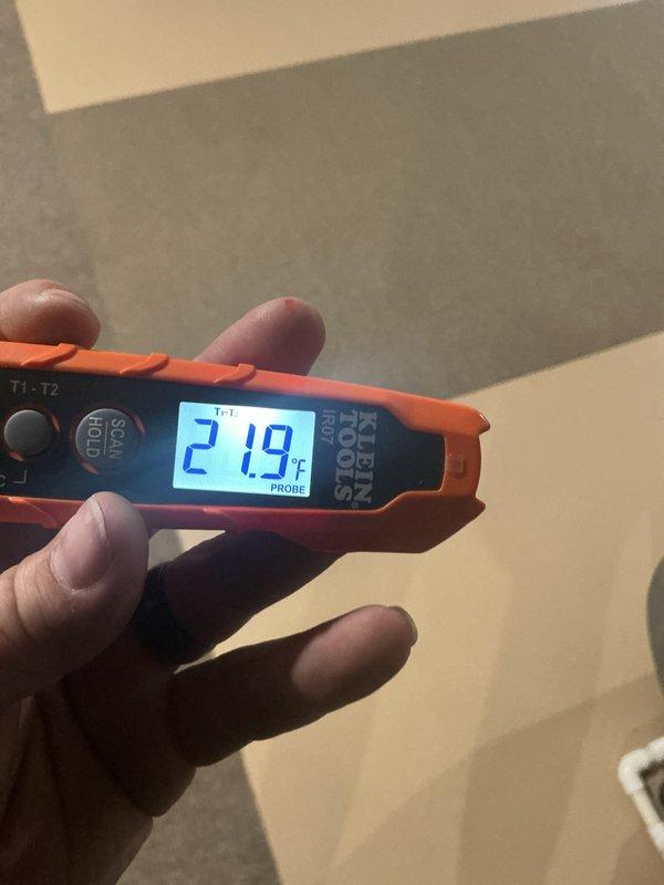 Completed annual cooling maintenance on residential air conditioning system. Performed standard ACM inspection protocol including temperature differential measurements using digital thermometer, which recorded 21.9°F across the system. Inspected air handler unit, verified proper condensate drain operation and PVC drain line configuration, and confirmed all mechanical components operating within normal parameters. No service issues identified during inspection; system functioning properly with no repairs needed at this time.