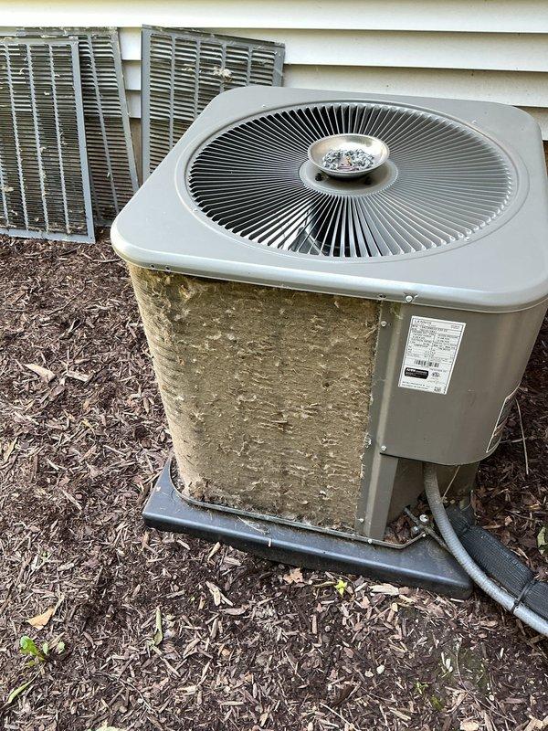 Completed comprehensive ComfortGuard Maintenance Package on residential outdoor air conditioning condenser unit. Performed standard preventive maintenance procedures including system inspection, cleaning of exterior components, and verification of proper operation. Unit showed significant environmental weathering and organic debris accumulation on exterior panels, which is typical for outdoor equipment exposure; documented existing cosmetic condition with photographs for service records.