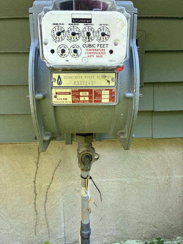 Conducted comprehensive site assessment for whole-home standby generator installation with focus on Kohler system specification. Evaluated existing electrical service, natural gas meter infrastructure, and load requirements including deep-well water pump, central air conditioning, electric range, and power-vented gas water heater. Documented current utility connections and meter locations through photographic survey of electric and gas meter installations on exterior wall. Analyzed client's specific power quality concerns regarding frequent brownouts, voltage sags, and grid flickering conditions requiring automatic transfer switch with voltage protection capabilities for sensitive electronics and appliances.