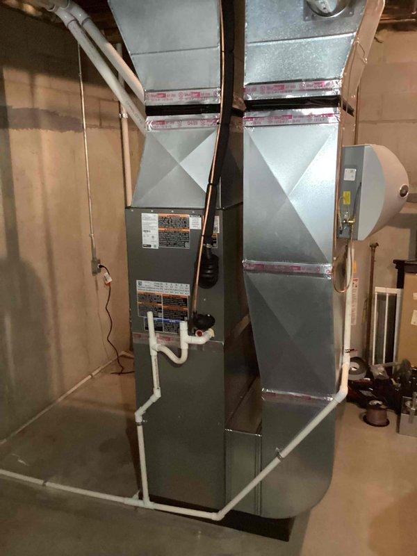 Completed full HVAC system installation in residential basement including 70,000 BTU furnace with humidifier, 2.5-ton air conditioning unit with evaporator coil in left-side configuration. Installed all necessary condensate drainage piping, ductwork connections, and electrical reconnections. Mechanical permit obtained prior to installation. System tested and operational upon completion, with all equipment properly positioned and secured in unfinished utility space.