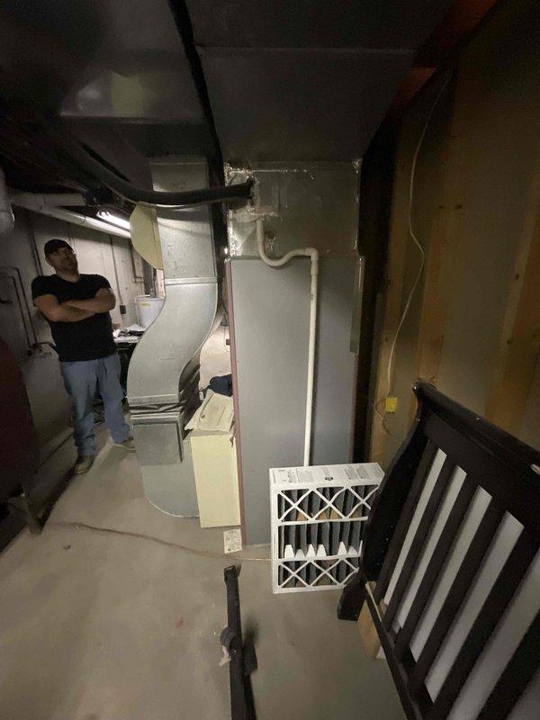 Conducted full system estimate for replacement of existing 16-year-old oil furnace and 15-year-old non-functional air conditioning system. Customer requested conversion from oil to propane heating fuel. Documented existing basement-installed furnace with ductwork and exterior AC condenser unit positioned in landscaped corner area. Assessed current HVAC infrastructure, ductwork configuration, and utility connections to provide comprehensive replacement options for complete propane furnace and air conditioning system installation.