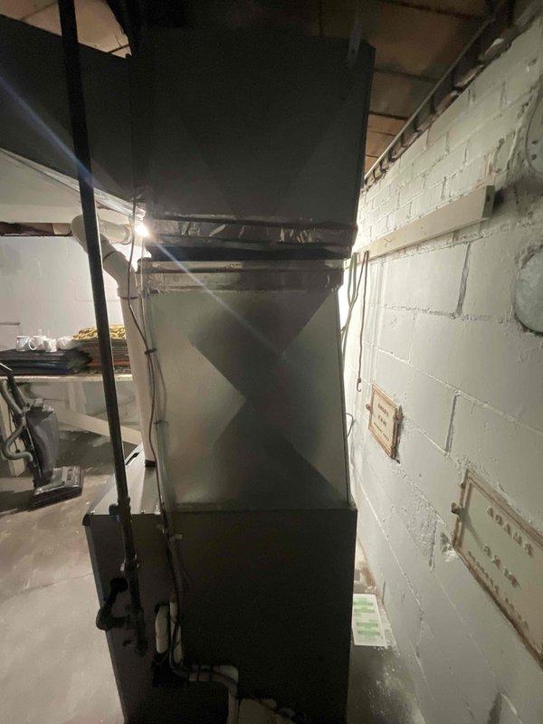 Conducted site evaluation for new central air conditioning system installation at property with no existing central air infrastructure. Assessed electrical panel capacity and circuit breaker configuration to determine adequacy for AC system power requirements. Evaluated existing furnace installation and ductwork compatibility for integration with proposed cooling system. Documented current HVAC equipment condition and utility room layout, including available space for condenser placement and refrigerant line routing. Photographed electrical service panel and mechanical room to support equipment sizing and installation planning. Provided comprehensive estimate for complete central air conditioning system installation with projected timeline for installation in early 2026.