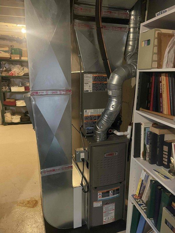 Completed full HVAC system installation including a Lennox 70,000 BTU furnace in basement mechanical room and Lennox 2.5-ton air conditioning condenser unit in rear yard. Installed furnace with proper ductwork connections, sheet metal plenum with sealed seams, and flexible supply ductwork routed upward from unit. Positioned outdoor condenser on pad with proper clearances, completed refrigerant line connections, electrical hookups, and condensate drainage. All equipment tested and operational upon completion.