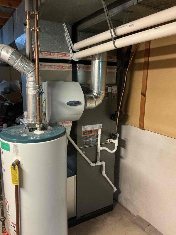 Completed full HVAC system installation including a 90,000 BTU furnace with integrated humidifier and 3-ton Lennox air conditioning condenser unit. Installed furnace in basement mechanical room with proper ductwork connections and mounted humidifier to supply plenum. Positioned AC condenser on exterior concrete pad against house foundation with refrigerant lines reconnected to indoor coil. Permit was obtained for mechanical-only work prior to installation. All equipment installed per manufacturer specifications with proper electrical connections, condensate drainage, and airflow configuration. System tested and operational upon completion. Submitted required financing documentation through electronic signature platform for processing.