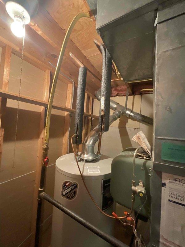 Conducted on-site evaluation for furnace replacement estimate. Assessed existing 20-year-old furnace system located in basement mechanical room alongside water heater. Documented current equipment configuration including ductwork layout, venting arrangements, and spatial considerations for replacement unit installation. Customer requesting replacement within three-month timeframe due to age of existing equipment.