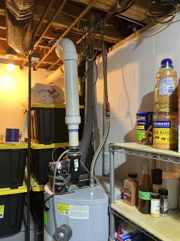 Responded to service call for water heater leak in 29-year-old residence. Upon arrival, inspected gray tanked water heater unit located in basement utility area and identified active leak that had been present for approximately 5 days. Conducted thorough visual inspection of tank, connections, pressure relief valve, and supply lines to determine source of water intrusion. Documented existing conditions with photographs showing water heater installation, surrounding plumbing connections, and evidence of moisture damage on concrete floor. Given the age of the unit and nature of the leak, provided assessment and recommendations for repair or replacement options to address the issue and prevent further water damage to the property.