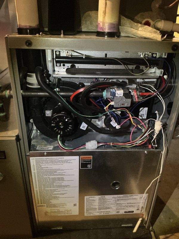 Completed comprehensive 5-year ComfortGuard maintenance visit on Lennox residential HVAC system. Performed thorough inspection of furnace interior components including blower motor assembly, electrical connections, control boards, and wiring harnesses. Examined humidifier evaporator pad, noting mineral deposit accumulation and moisture saturation levels in lower section; verified water supply line connections and proper operation. Inspected all safety controls, ductwork connections, and PVC condensate drainage system. Confirmed proper function of all mechanical and electrical components throughout the heating system.