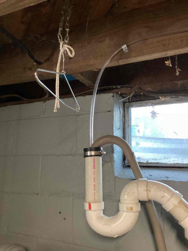 Completed installation of a 2-ton air conditioning system with matching evaporator coil at rear of residence. Installed new outdoor condensing unit on pad with refrigerant line set routed along exterior wall, mounted electrical disconnect box, and established new dedicated electrical circuit. Interior work included evaporator coil installation with PVC condensate drain line and trap configuration in basement utility area. All mechanical and electrical permits were obtained prior to installation, system was properly charged, tested for proper operation, and left running efficiently.
