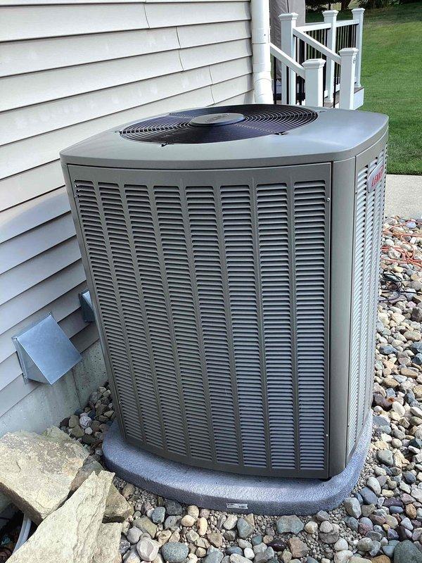 Completed full HVAC system installation including a 90,000 BTU gas furnace with humidifier installed in basement utility room and a 4-ton air conditioning condensing unit positioned on exterior concrete pad with proper refrigerant line connections. All PVC condensate drainage lines, electrical conduit, and ductwork connections were installed per code requirements. System was tested, started up successfully, and left in full operational condition with all necessary permits obtained.