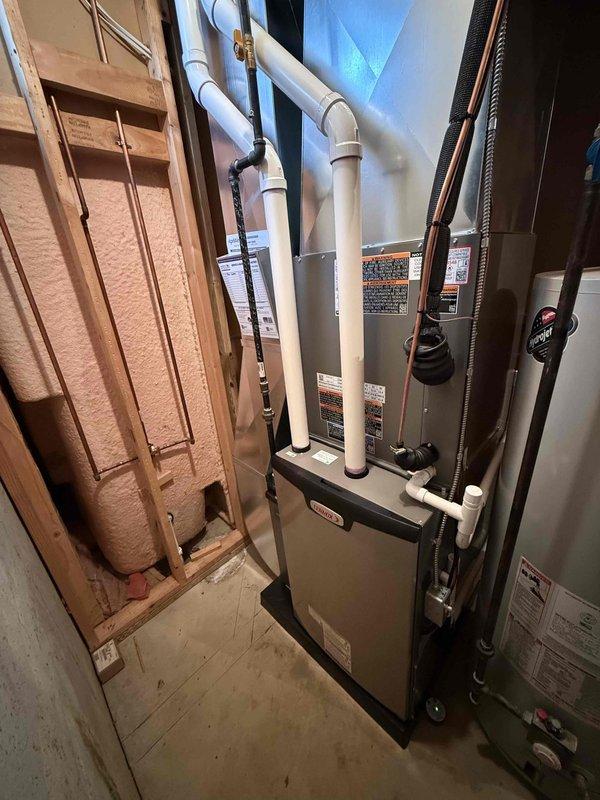 Completed full HVAC system installation including 90,000 BTU furnace, 3-ton air conditioning unit with evaporator coil, and humidifier in residential mechanical room. Installed all necessary refrigerant lines, condensate drainage with PVC piping, electrical connections, and ductwork reconnections. System tested and operational, with mechanical permit obtained for furnace installation only per specifications.