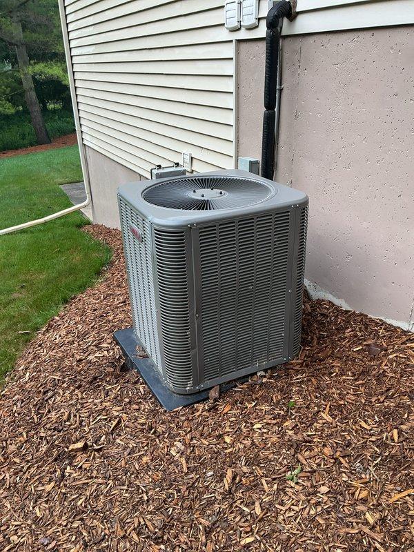 Completed annual cooling maintenance on residential split system air conditioning unit. Performed comprehensive inspection of outdoor condensing unit including visual assessment of cabinet condition, fan motor operation, and refrigerant line connections. Verified proper unit placement on concrete pad with adequate clearance for airflow. Inspected electrical conduit and connections for secure mounting and proper installation. Confirmed condensate drain line routing and functionality. Unit showed no visible signs of damage, excessive wear, or debris accumulation. All components operating within normal parameters at time of service.