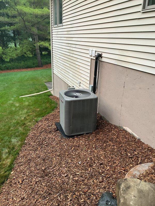 Completed annual cooling maintenance on residential split system air conditioning unit. Performed comprehensive inspection of outdoor condensing unit including visual assessment of cabinet condition, fan motor operation, and refrigerant line connections. Verified proper unit placement on concrete pad with adequate clearance for airflow. Inspected electrical conduit and connections for secure mounting and proper installation. Confirmed condensate drain line routing and functionality. Unit showed no visible signs of damage, excessive wear, or debris accumulation. All components operating within normal parameters at time of service.