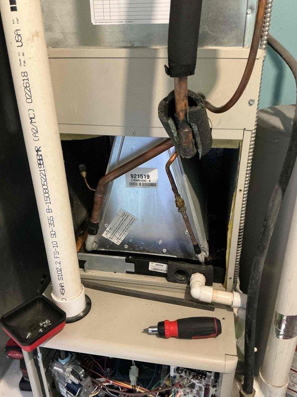 Responded to service call for water leakage from furnace during air conditioning operation in basement location. Upon inspection, identified issue with drain pan assembly and condensate drainage system. System was shut off to prevent further water damage and assess HVAC components including evaporator coil assembly and associated drainage infrastructure.