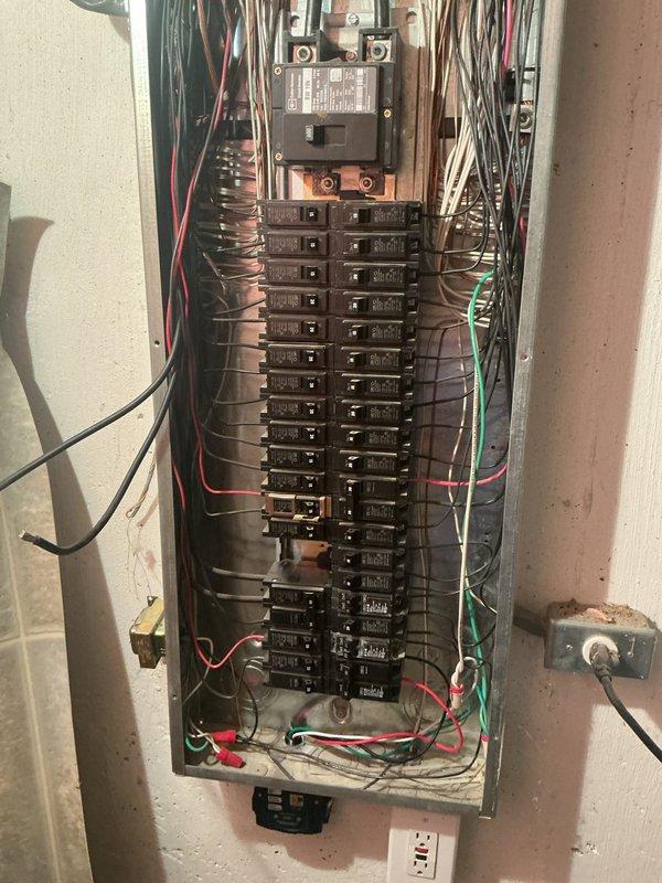 Responded to service callback for tripping breaker affecting 6-year-old A/C unit located in basement. Inspected main electrical panel and circuit breaker configuration, verified proper breaker sizing and connections for A/C circuit, and documented panel condition with circuit directory labeling. Resolved breaker tripping issue to restore cooling system operation.