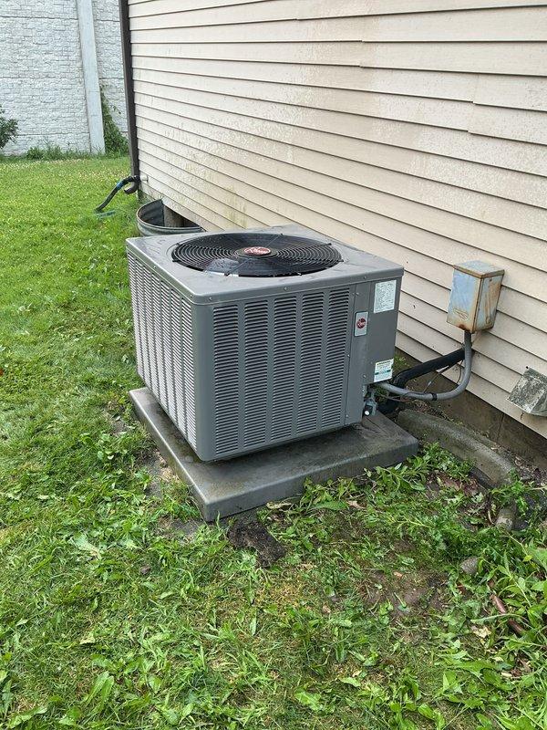 Responded to no cooling call on residential Rheem air conditioning system. Upon arrival, customer reported unit was now operating properly. Converted service call from repair to preventative maintenance tune-up. Performed complete system inspection of outdoor condenser unit, verified proper operation of compressor and condenser fan motor, checked electrical connections at disconnect box, and confirmed adequate airflow through condenser coil. Unit found in good operating condition with no immediate repairs required.
