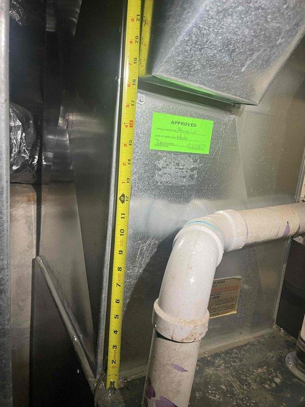 Conducted site assessment for new air conditioning system installation at property with no existing AC system. Evaluated mechanical room space and existing HVAC equipment, taking detailed measurements of available clearances around current furnace/air handler unit to determine proper sizing and placement requirements for new cooling equipment. Documented vertical and horizontal spacing constraints, existing ductwork configuration, and condensate drain line routing to provide comprehensive estimate for complete AC system installation.