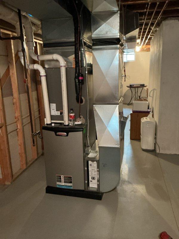 Completed annual cooling maintenance on residential HVAC system. Inspected air filter showing moderate dust accumulation along bottom edge, checked furnace unit and associated ductwork components for proper operation, and verified all mechanical systems in basement installation were functioning within normal parameters.