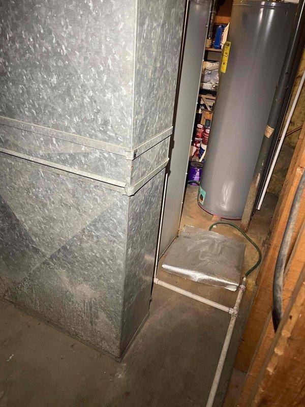 Conducted comprehensive assessment of existing HVAC system for complete replacement estimate. Inspected 40-year-old oil-fired furnace with Beckett burner assembly showing significant age-related wear, accumulated dust, oil staining, and surface discoloration throughout cabinet interior. Evaluated air conditioning system and existing ductwork configuration in basement mechanical room. Documented equipment conditions through detailed photography of furnace cabinet interior, burner components, electrical connections, and surrounding utility area layout. Assessed accessibility for equipment removal and new system installation. Provided recommendations for complete furnace and air conditioning replacement to meet current efficiency standards and customer requirements.