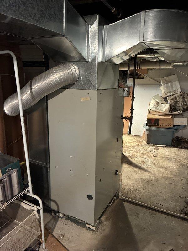 Completed estimate for replacement of 20+ year old natural gas furnace and new air conditioning system installation in basement location. Current furnace is operational but aged beyond recommended service life. Evaluated existing ductwork system, including flexible and rigid metal ducting, electrical connections, and venting configuration to determine specifications for replacement equipment and new AC system integration.