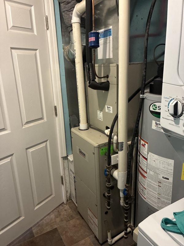 Provided comprehensive estimate for complete air conditioning system replacement at residential property. Existing 11-year-old A/C unit is non-operational and located in utility closet alongside HVAC air handler and water heating equipment. Documented current equipment configuration including gas valve assembly, manufacturer specifications, and existing mechanical room layout with multiple utility systems. Customer qualifies for service credit as Air Care Member.