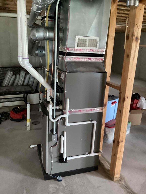 Completed full HVAC system installation including a Lennox 70,000 BTU gas furnace, 2-ton air conditioning unit (model ML14XC1S-024-7J), and whole-home humidifier in basement location. Performed all mechanical and electrical connections, installed PVC venting and condensate drainage systems, connected supply and return ductwork with flexible transitions, and reconnected existing electrical circuits to new equipment. System tested and operational upon completion, with utility rebate applications submitted to BWL and Consumers Energy, and financing documentation processed through Michigan Saves program.