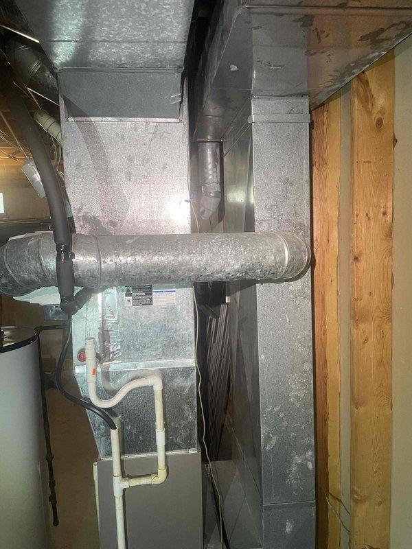 Performed estimate for air conditioning system replacement in basement location. Existing unit is non-operational and outdated. Documented current HVAC equipment configuration including air handler, ductwork system, and condensate drainage lines. Assessed installation area showing metal supply and return ducts with significant dust accumulation, PVC condensate piping, and electrical connections. Measured existing equipment dimensions and clearances for replacement unit specifications. Provided comprehensive estimate for complete A/C system replacement with applicable service credit toward new installation.