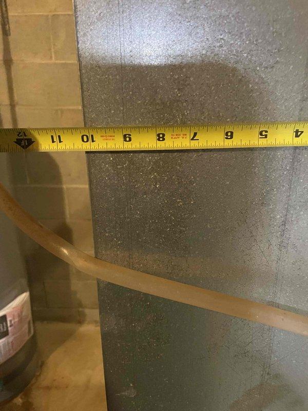 Performed comprehensive assessment of existing HVAC system for full replacement estimate. Inspected 40-year-old furnace (original 1986-87 installation) and 35-year-old air conditioning unit (installed circa 1992). Current system remains operational but air conditioner utilizes obsolete R-22 refrigerant and demonstrates inadequate cooling performance. 

Measured and documented existing ductwork diameter and heat exchanger dimensions to determine proper equipment sizing requirements. Evaluated installation conditions in mechanical room including clearances, structural supports, and existing infrastructure. Documented current system configuration through photographs of duct measurements and evaporator coil assembly showing age-related wear and dust accumulation on metallic fins.

Provided estimate for replacement with 3-ton 16 SEER air conditioning unit and 80,000 BTU 96% AFUE efficiency furnace suitable for existing residential application. Recommended full system replacement due to age 