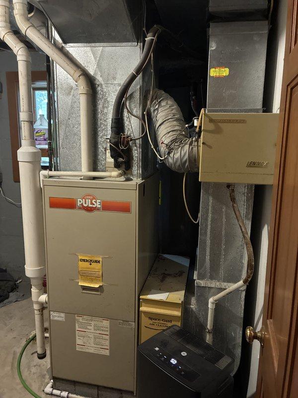 Conducted full system estimate for replacement of 16-year-old Lennox Pulse furnace and matching air conditioning unit in basement installation. Customer reported declining AC efficiency and impending failure, with both heating and cooling systems reaching end of serviceable life. Documented existing equipment configuration, ductwork layout, venting system with PVC exhaust, and available space for new installation to provide comprehensive replacement options for complete HVAC system upgrade.