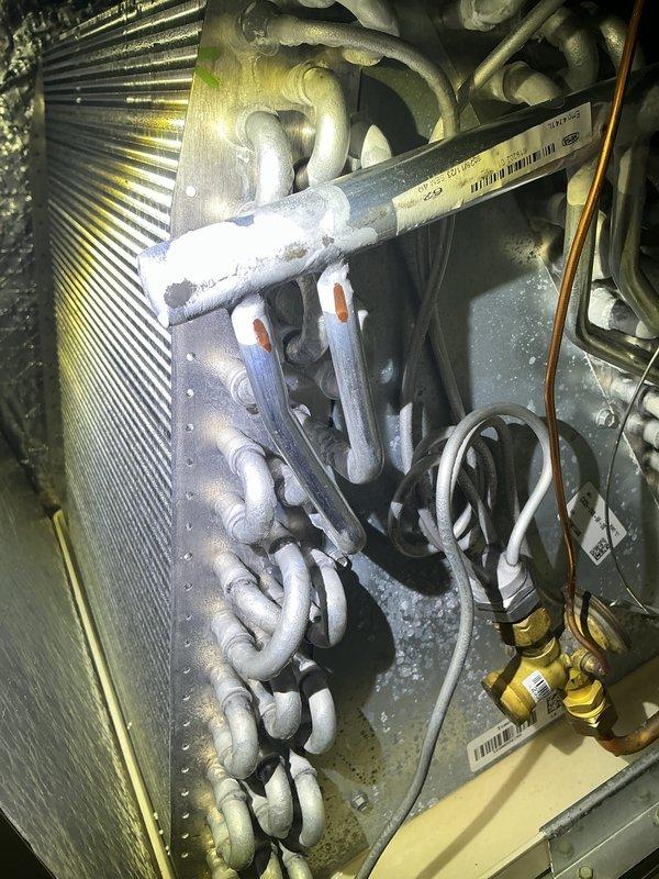 Completed annual HVAC maintenance inspection and documented system conditions. Observed heavy frost accumulation on refrigerant lines and U-bend copper tubing at the evaporator coil, indicating potential airflow restriction or refrigerant charge issues requiring further evaluation. Inspected and documented humidifier assembly with water panel evaporator in serviceable condition.