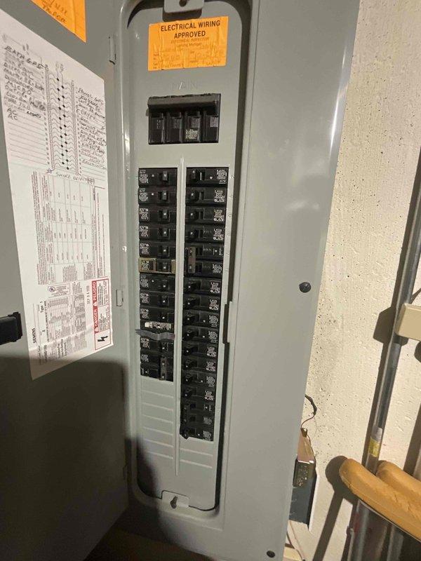 Completed electrical estimate for Generac generator installation with ComfortGuard Maintenance Package. Evaluated existing electrical panel infrastructure and circuit breaker configuration to determine compatibility and capacity requirements for generator integration. Documented current electrical system setup including main breaker panel with dual columns of circuit breakers and verified electrical wiring approval compliance for proposed generator connection.