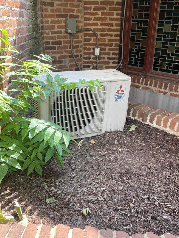 Completed estimate for replacement of existing Mitsubishi mini split system serving 10x10 office area. Assessed current outdoor condensing unit mounted on exterior brick wall and indoor air handler with refrigerant line set. Documented existing installation including electrical disconnect, conduit routing, and line set penetration through building envelope. Photographed equipment condition and installation configuration to prepare comprehensive replacement proposal for commercial mini split system.