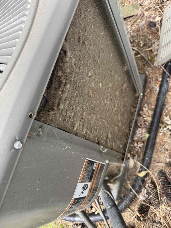 Responded to no cooling complaint on a three-year-old residential air conditioning system. Upon arrival, performed visual inspection of outdoor condenser unit and discovered heavily soiled air filter caked with dust, dirt, and debris restricting airflow to the system. Removed and documented the severely clogged filter which was causing reduced cooling capacity and inadequate temperature control throughout the home. The restricted airflow was preventing the system from operating at designed efficiency levels, resulting in the inability to maintain comfortable indoor temperatures. Cleaned accessible components and recommended filter replacement to restore proper system operation and airflow.